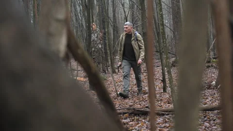 Man hiking through a forest with a backpack on a cloudy day Stock Footage 307855750
