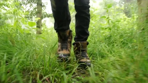 Man Hiking through Nature. Low Angle Boots Walking through Forest Woodland Stock Footage 111237451