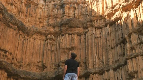 Man hiking through sandstone cliffs. Video stock 251889273