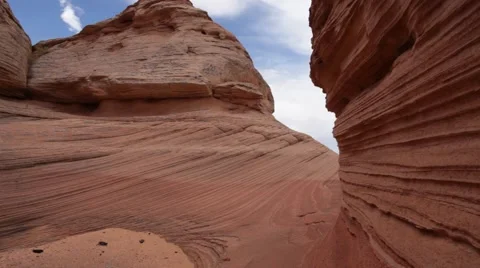 A man hiking through sandstone formations in the desert Stock Footage 66806554