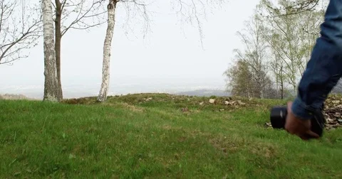 Man hiking through woods looking for photos. Following behind.Real people 動画素材 80126866