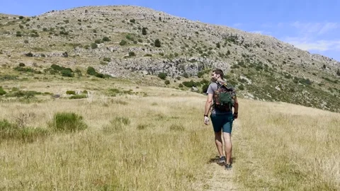 Man Hiking Toward Mountain Summit on Trail, Tracking Shot Stock Footage 338007212