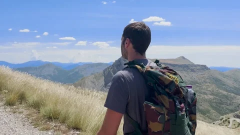 Man Hiking Toward Mountain Summit on Trail, Tracking Shot Stock Footage 338007238