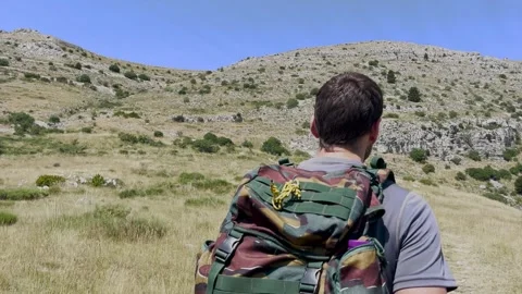 Man Hiking Toward Mountain Summit on Trail, Tracking Shot Stock Footage 338007239