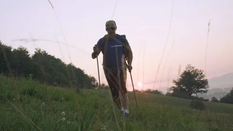 Man On A Hiking Trip Walking In Front Of The Sunrise Towards The Camera Stock Footage 93660974