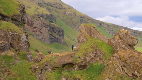 Man hiking on uneven path with uphills and downhills in icelandic mountains Stock Footage 258489226