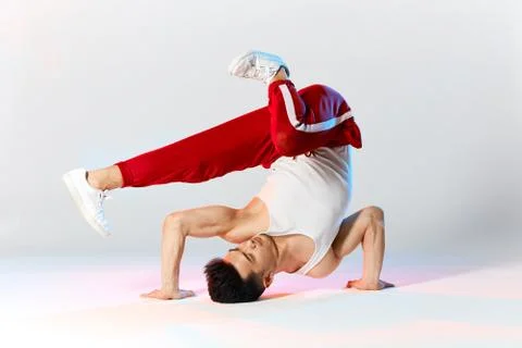 A man hip hop dancer or bboy freezes in one pose on the hand Stock Photos