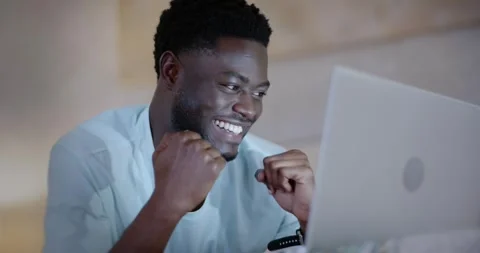 Man in his 20s at home seeing laptop notification, shifting focus into Stock Footage 343888631