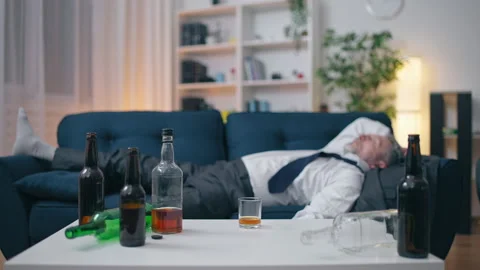 Man in his 50s sleeping after drinking a lot, alcohol addiction, problems Stock Footage 202305224