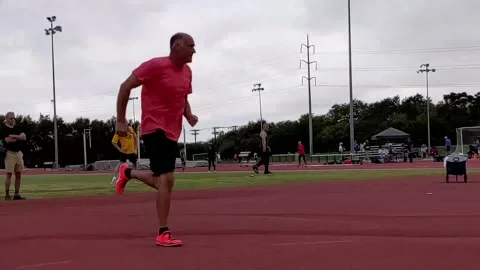 Man in his 60's attempting high jump at local track meet for senior athletes 動画素材 227041130