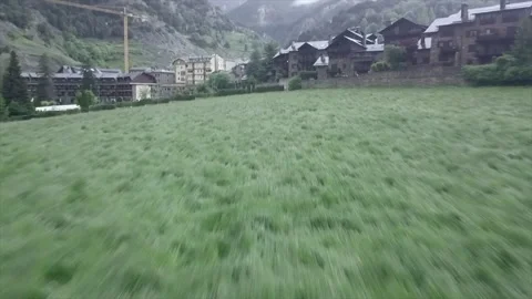 Man on his back flies drone over mountain village Video stock 221516594