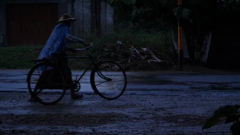 A man with his bycicle in Yangon periphery by night, Burma, Asia in 4K Stock Footage 94712792
