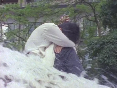 Man with his head down sitting on gushing water Stock Footage 79878015