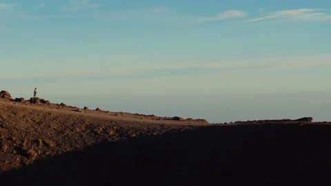 A man with his kid walking on the edge of Mount Etna Stock Footage 88568471