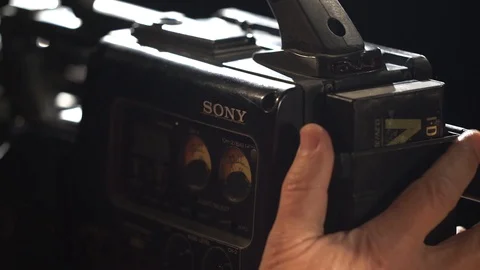 Man in his office inserts a cassette into a camera Vídeo Stock 114428805