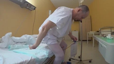 A man in his prime barely gets up after surgery. Stock Footage 124081923