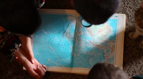 A man, his sons and a cat studying geography Vídeo Stock 60644876