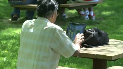 Man on his tablet outdoors (1 of 1) Video stock 20026069