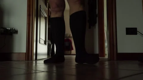 Man in his underwear walking with a tablet Stock Footage 314857997