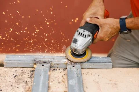 A man in his yard is engaged in locksmith work. Hobby, in a home workshop. Stock Photos
