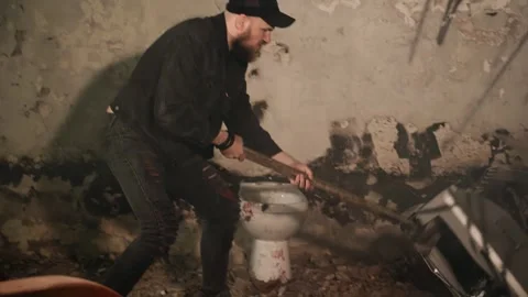 A man hits an old TV with a sledgehammer with all his might Stock Footage 245556901