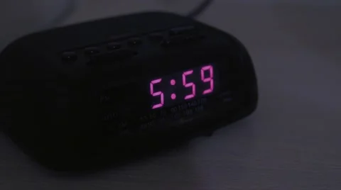A man hits snooze on alarm clock Stock Footage 48528846