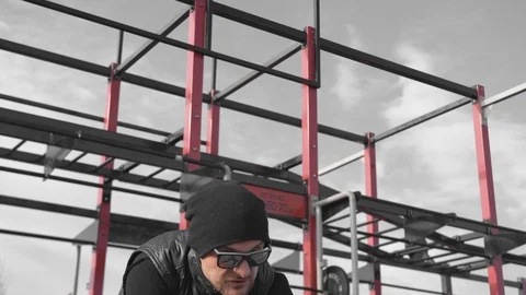 A man hits the wheel with a hammer. Playing sports. Bringing himself into shape. Stock-Footage 126372819