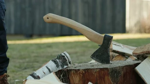 Man Hitting An Axe Into A Tree Stump After Chopping Wood Stock Footage 238525339