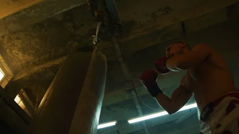 Man hitting a boxing bag Stock-Footage 100036758