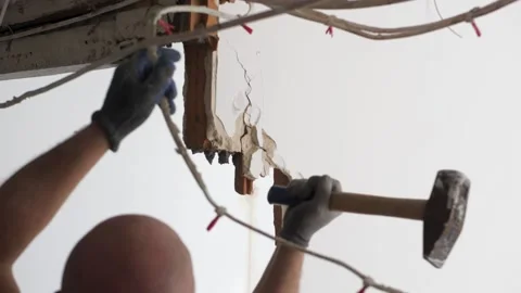 Man hitting a brick wall with a hammer, wall demolition Stock Footage 169852275