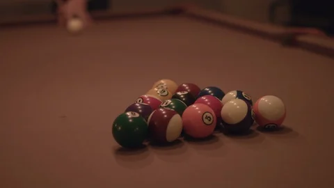 Man hitting the cue ball and breaking on a pool table in 4k. Stock Footage 88684788