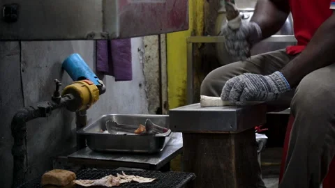 MAN HITTING DRY SQUID Stock Footage 196854632