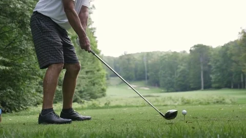 Man hitting golf ball in slow motion Stock Footage