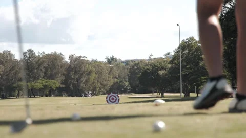 Man Hitting a Golf Ball at a Target Stock Footage 304484561