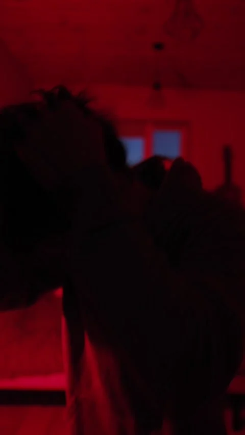 Man hitting his head and grabbing hair, close-up emotional breakdown in red Video stock 329181651