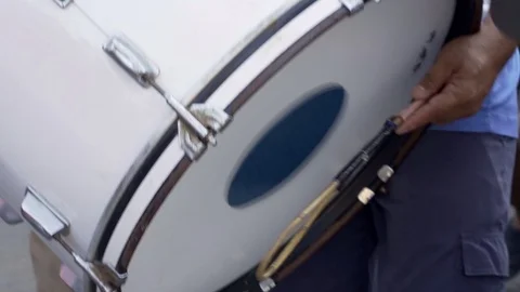 Man hitting or playing giant drum in parade of music instrument concept Stock Footage 119378676