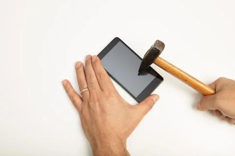 Man hitting a smartphone screen with a mallet Stock Photos