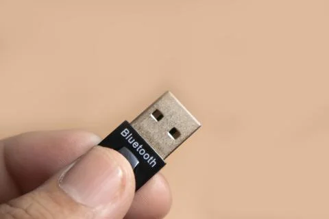 A Man Hold a Bluetooth device on hand Stock Photos