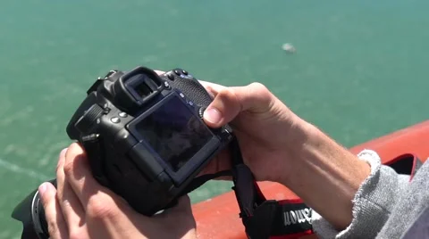 Man hold camera on Golden Gate Bridge looking at camera Stock-Footage 65556254