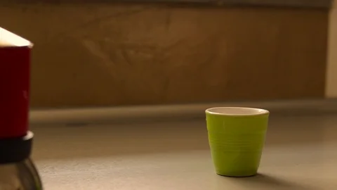 Man hold a coffeepot and drop hot coffee in a coffee cup Stock Footage 96599574