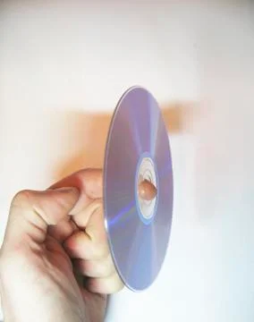 Man hold on the finger compact disk isolated on the white Stock Photos