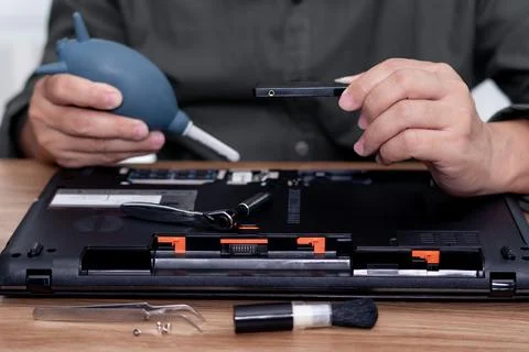 A man hold hard disk and hand air pump in repair laptop computer and tool c.. Stock Photos