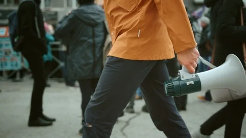 Man hold megaphone and shouting close up. Rebel loudspeaker on political strike. Stock Footage 121758631
