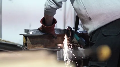 Man hold metal while grinding with disc tool Stock Footage 81859333