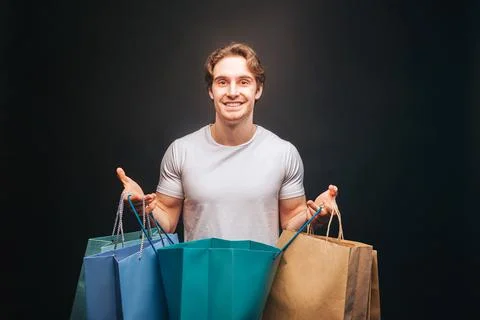 Man hold one opened and other clothes shop bags Stock Photos