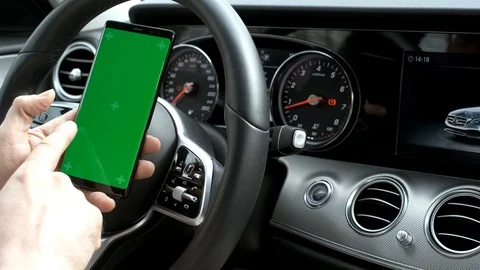 Man hold smartphone in car on dashboard background Stock Footage 106985346