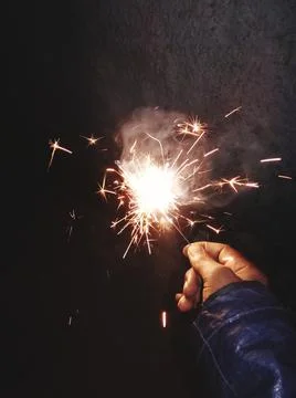 The man hold a spark light cracker Stock Photos