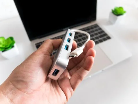 Man Hold the USB to Type C Adapter Converter with Laptop in the Background Stock Photos