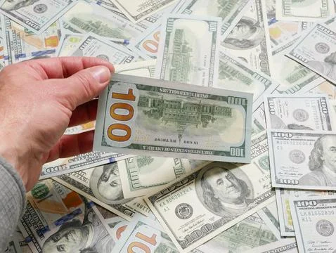Man holding 100 dollar notes, close up on hand. Stock Photos