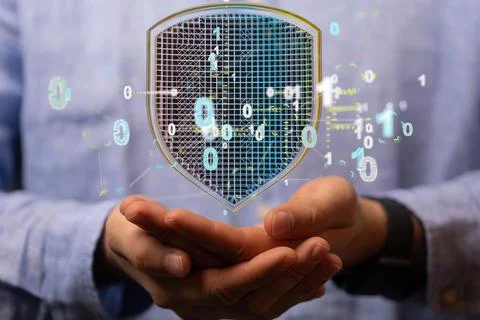 Man holding a 3D shield icon symbolizing data security and protection Stock Photos